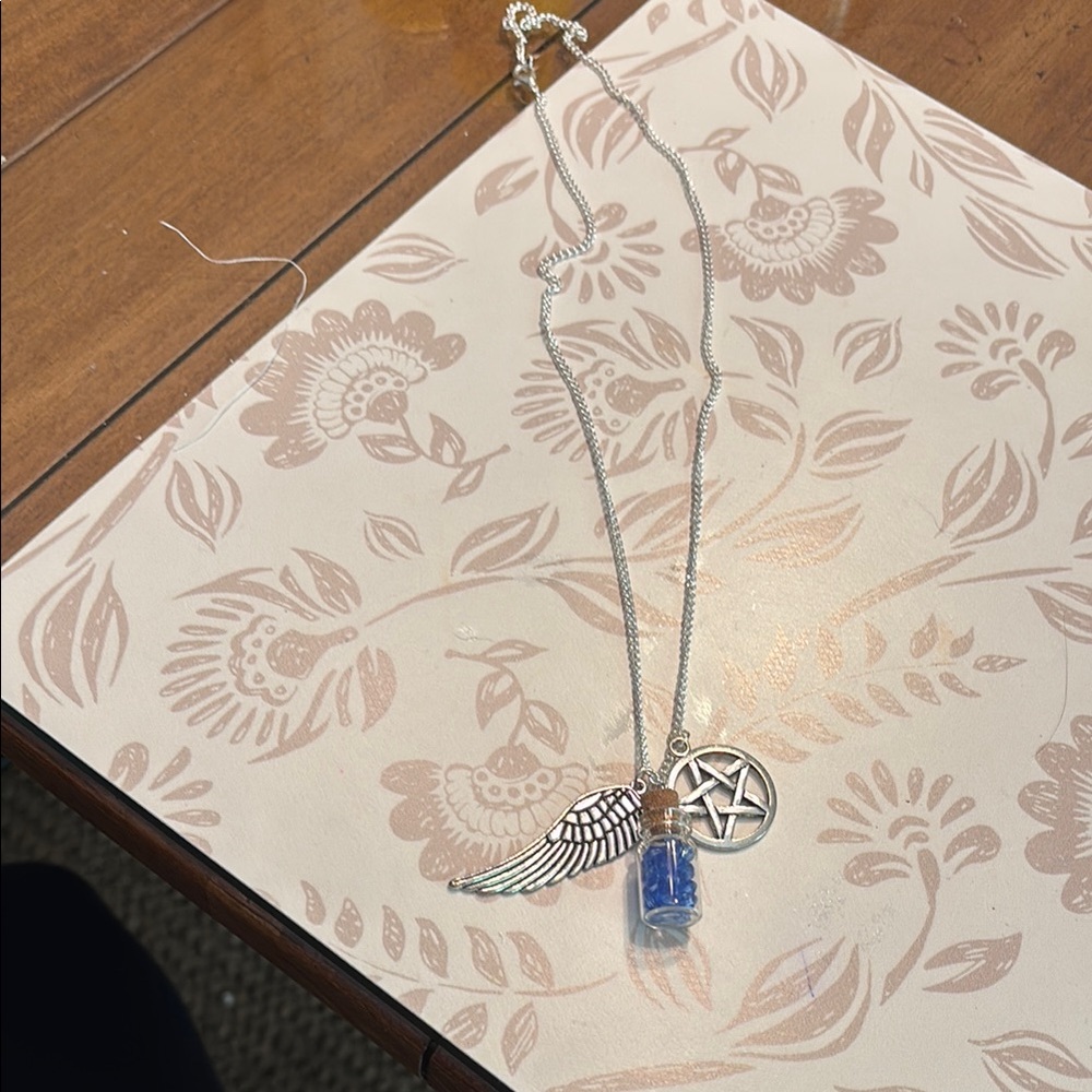 Silver Wing and Pentacle Necklace with Blue Vial